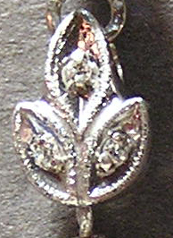 Photo of white gold watch part with 3 melee diamonds