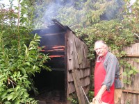 Owen Walker puts Sockeye Salmon in his Smokehouse