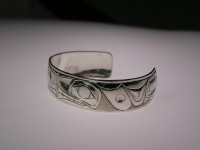 Photo of Hand carved sterling silver small whale bracelet side view