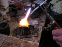 ingot mold being filled with moltensterling silver